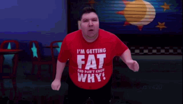 a man wearing a shirt that says fat why