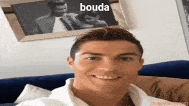 a man sitting on a couch with the word bouda above him