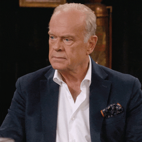 an older man wearing a blue jacket and a white shirt