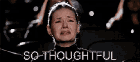 a woman is crying while sitting in a theater and the words `` so thoughtful '' are written above her .