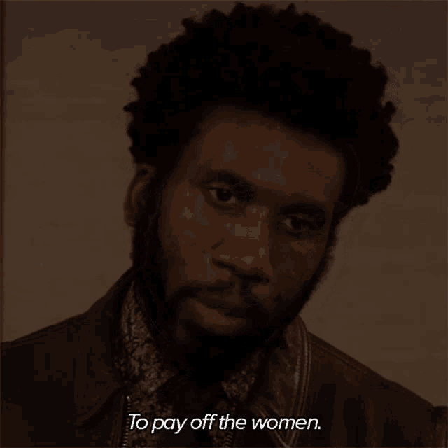 a man with a beard is talking about paying off the women
