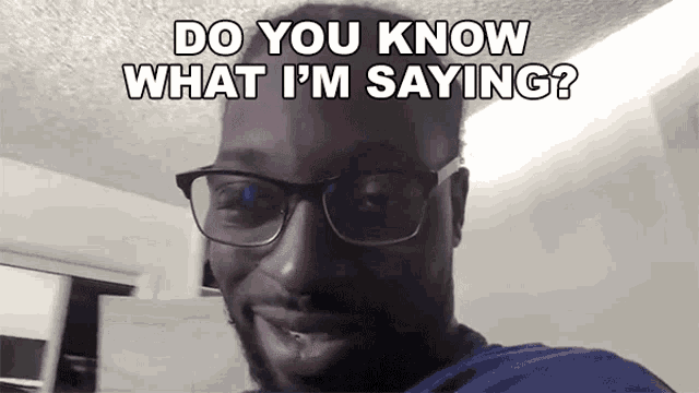 a man wearing glasses and a blue shirt says do you know what i 'm saying