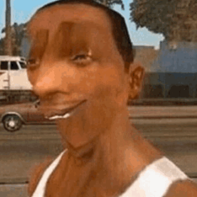 a man in a white tank top is making a funny face .