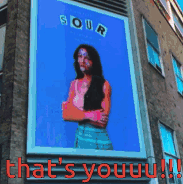 a billboard with a picture of a woman says sour that 's youuu