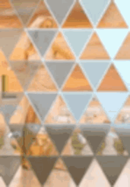 a blurred image of a triangle pattern on a window .