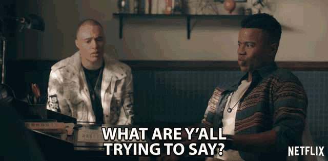 two men are sitting at a table with the words " what are y'all trying to say " above them