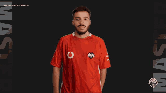 a man wearing a red shirt that says master league portugal on it