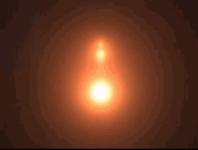 the sun is shining brightly in the dark sky with a blurred background .