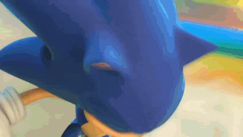 a close up of sonic the hedgehog 's face with a blurred background