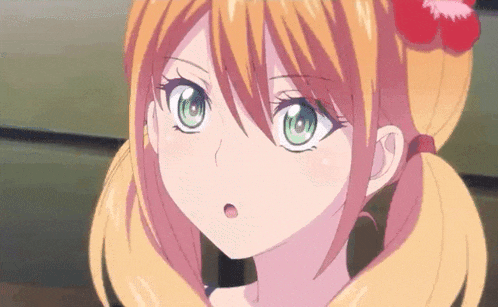 a close up of a girl with pigtails and green eyes looking at the camera .