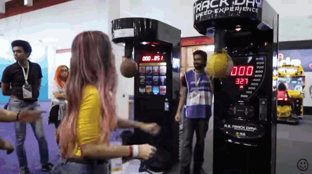 a woman stands in front of a boxing machine that says track day