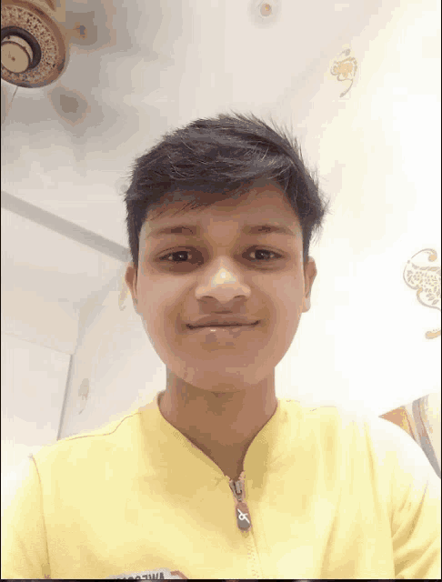 a young man wearing a yellow shirt with a zipper that says ' supreme ' on it
