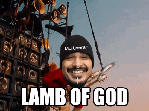 a man wearing a hat that says multivers on it is smiling and says lamb of god