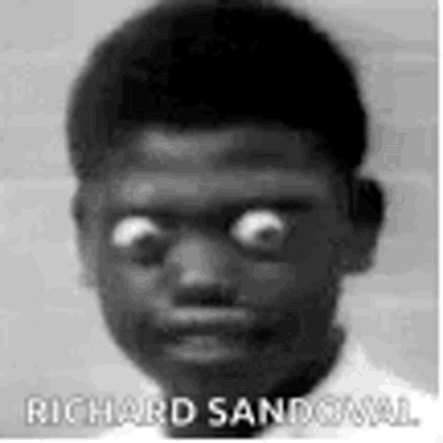a black and white photo of a boy with big eyes .