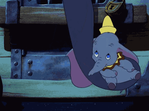a cartoon elephant is hanging from a trunk with a key on it