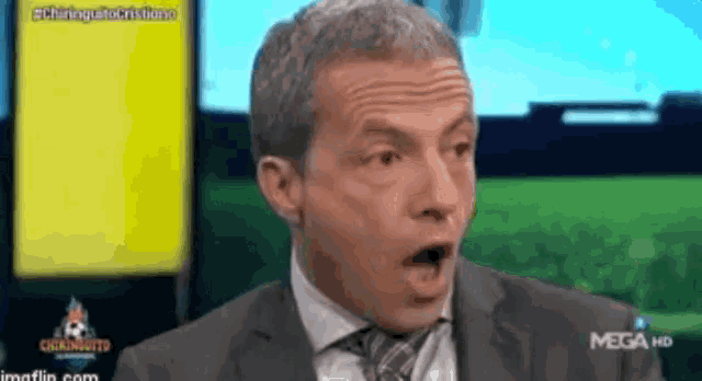 a man in a suit and tie with his mouth open is on a mega hd channel