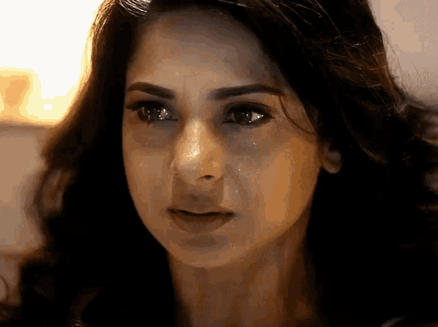 a woman with a tear running down her face