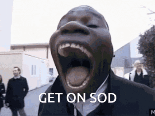 a man in a suit is screaming with his mouth open and the words `` get on sod '' written below him .