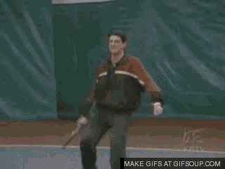 a man is swinging a wilson tennis racket on a tennis court
