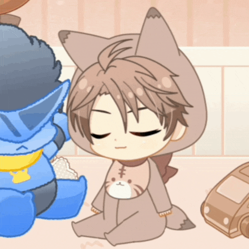 a baby in a fox costume is sitting on the floor with his eyes closed