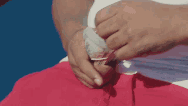 a person holding a stack of money in their hands