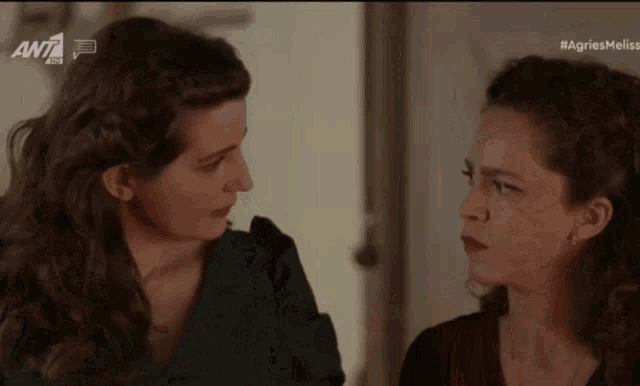 two women are looking at each other with the letters awt on the bottom