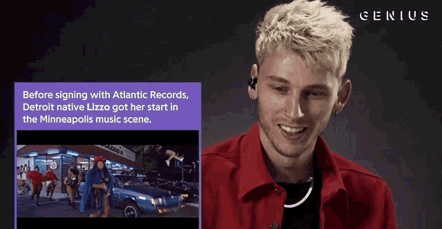 a man in a red shirt is smiling in front of a genius advertisement