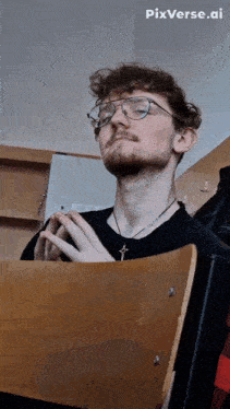 a man wearing glasses sits in a chair with pixverse.ai written on the bottom right