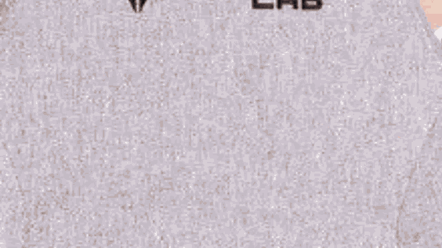 a girl with red hair is wearing a gray shirt with the word lab on it