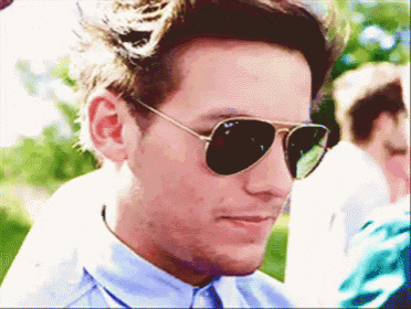 a man wearing sunglasses and a blue shirt