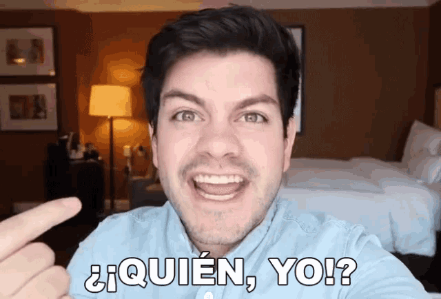a man in a blue shirt says " quien yo " in front of a bedroom