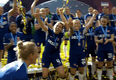 a group of female soccer players wearing blue uniforms with the number 4 on the front