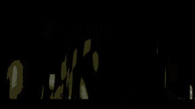 a close up of a teddy bear with glowing eyes in a dark room .