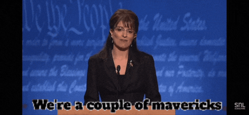 a woman stands at a podium with the words we 're a couple of mavericks