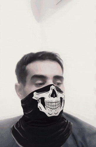 a man wearing a skull scarf around his face