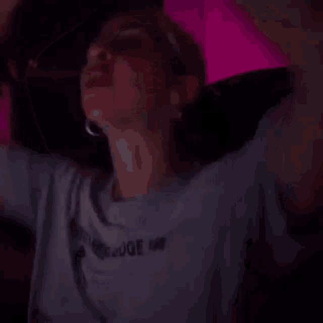 a woman with her arms in the air and the word fuck on the bottom