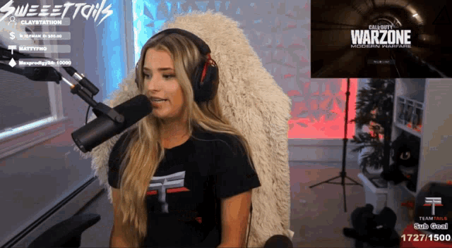 a woman sitting in front of a microphone with the word warzone on her screen