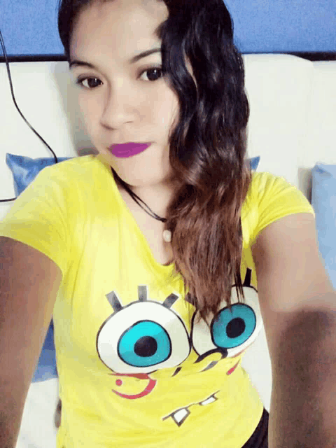 a woman wearing a yellow shirt with spongebob face on it