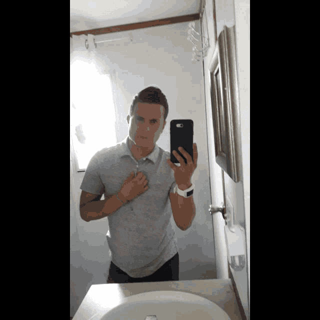 a man taking a picture of himself in the mirror