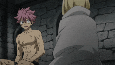 a man without a shirt sits next to another man