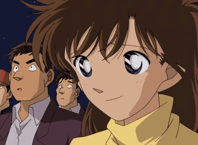 a girl with brown hair and blue eyes looks at something