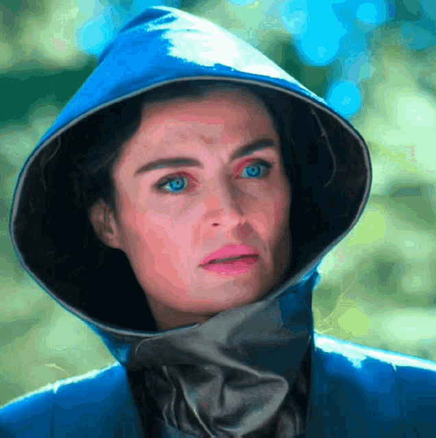 a woman wearing a blue jacket and a blue hood