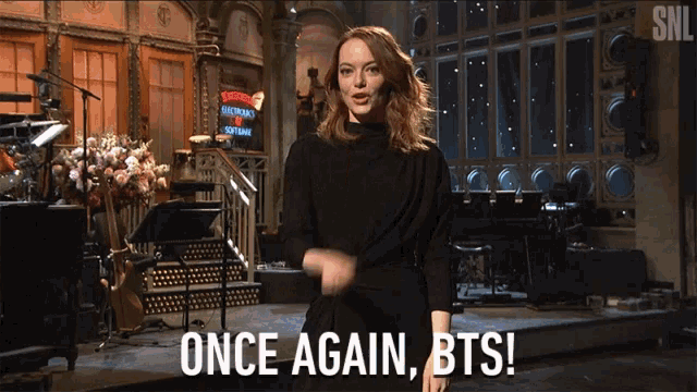 a woman in a black dress says once again bts on a stage