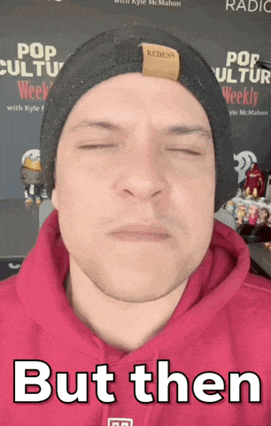 a man wearing a red hoodie and a black beanie has his eyes closed and the caption but then