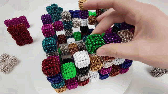 a person is playing with a bunch of colorful balls