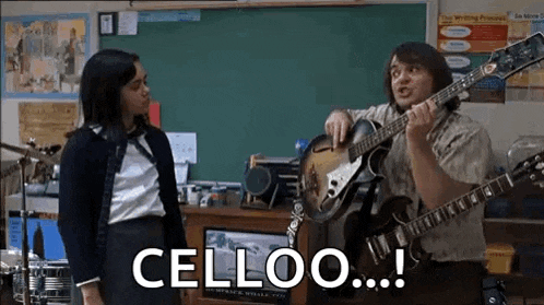 a man is playing a guitar in front of a girl in a classroom while a woman looks on .