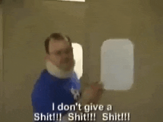 a man in a blue shirt is saying `` i don 't give a shit !!! ''