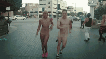 a man and a woman are walking naked down the street