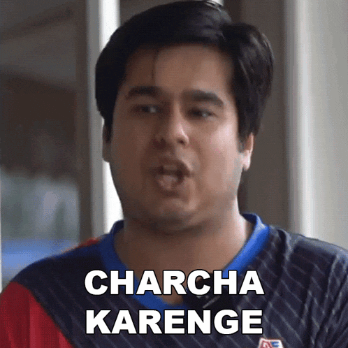 a man wearing a striped shirt says charcha karenge