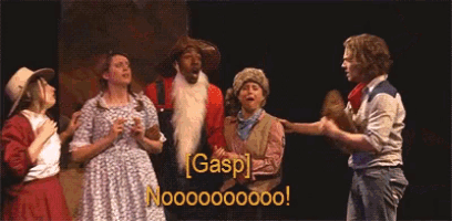 a group of people standing on a stage with gasp written in yellow letters